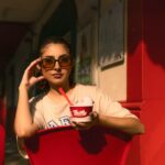 A fashionable woman enjoying ice cream in the sunny streets of Ciudad de México.